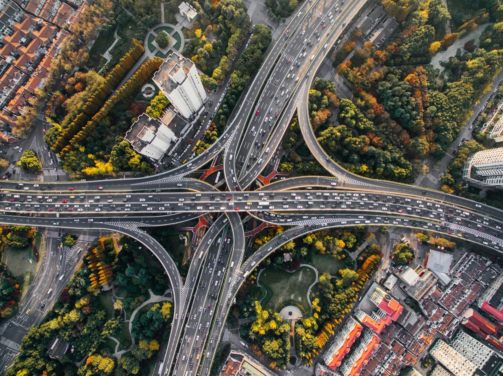 Aerial view of a multi-level highway interchange packed with traffic, lanes flowing in every direction